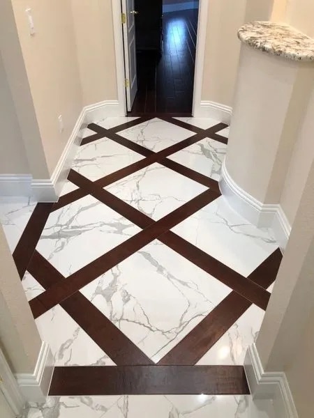 Porcelain tile floor laid on the diagonal with a hardwood inlay border